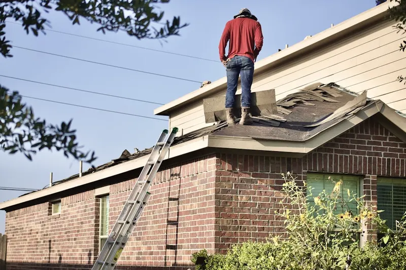 Professional roofer working on a residential roof in Wells